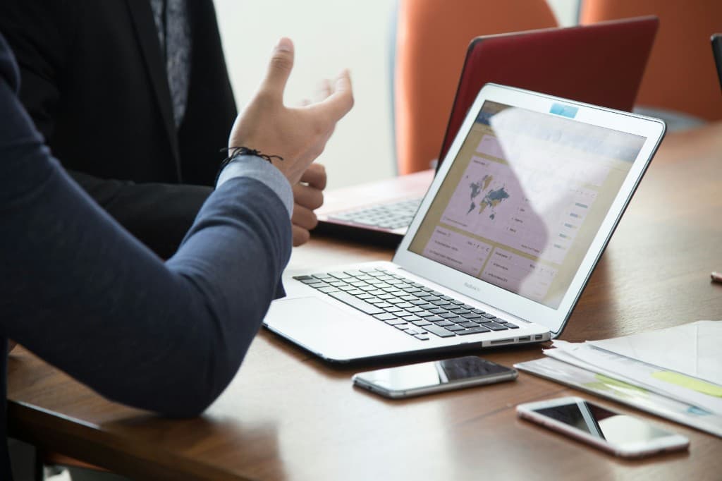 Colleagues reviewing partnership data together on a laptop