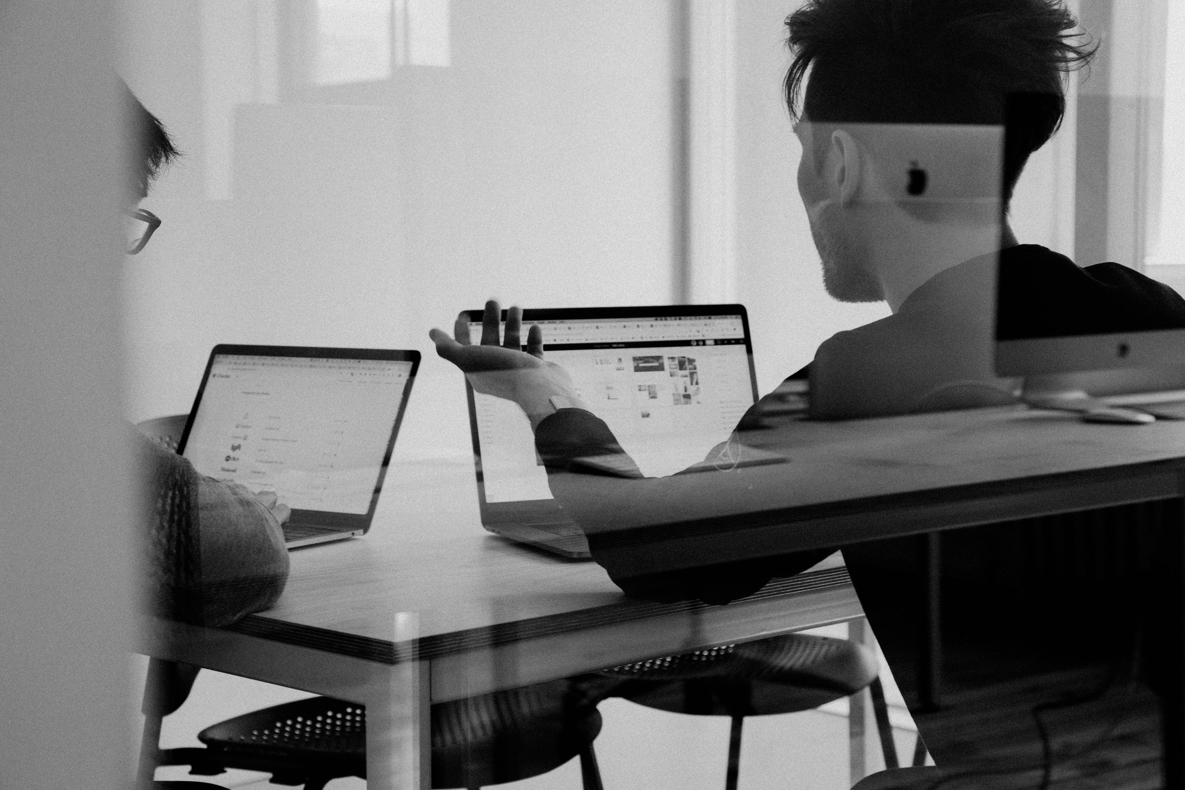 Colleagues reviewing partnership data together on a laptop