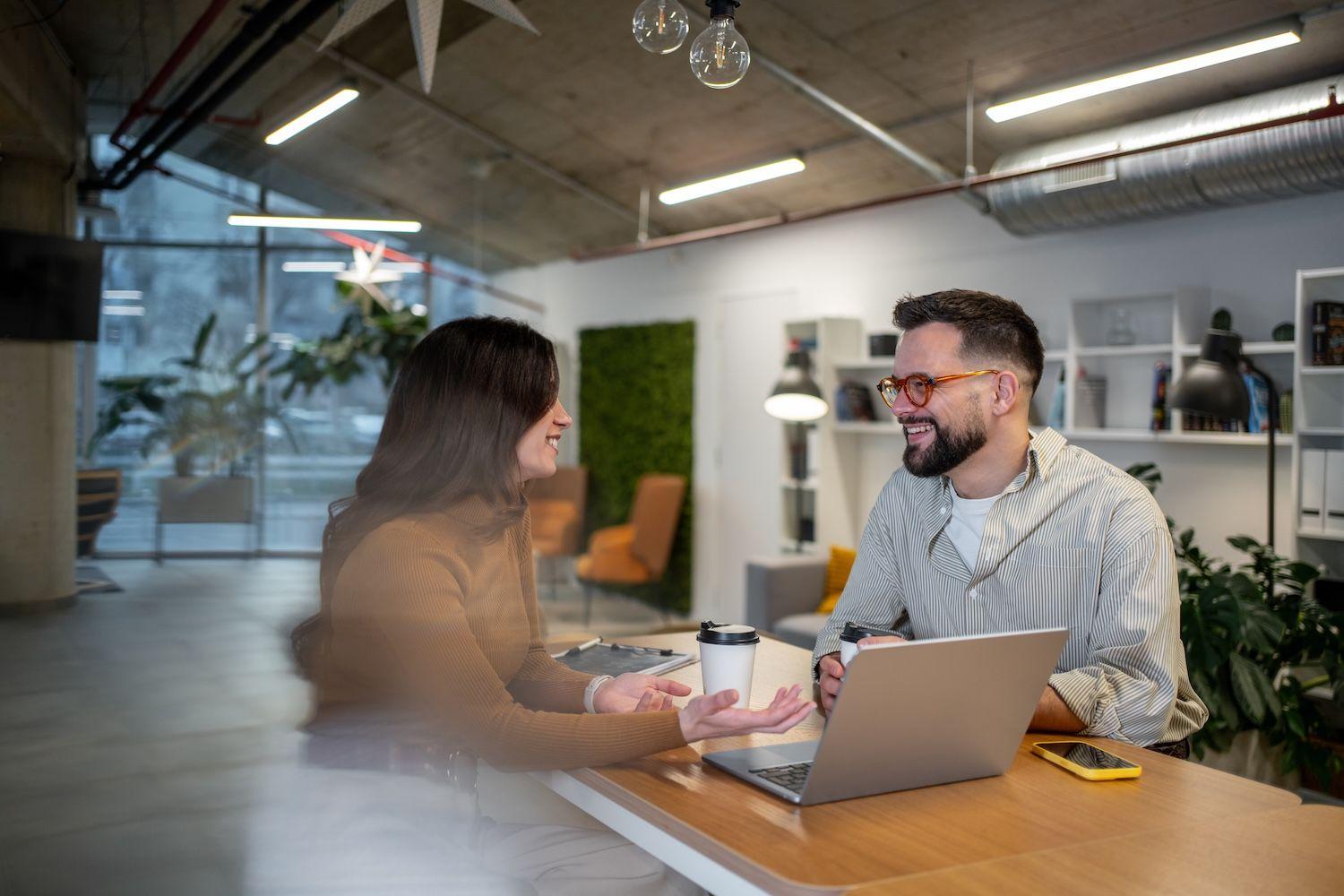 Colleagues reviewing partnership data together on a laptop